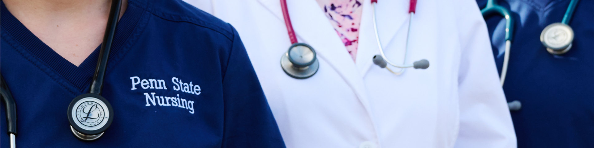 close up of three people in scrubs wearing stethoscope around their neck