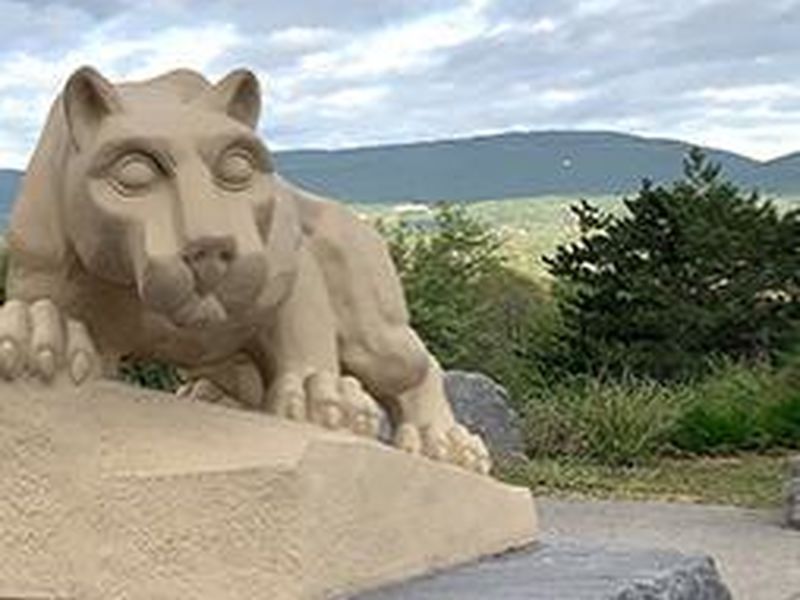 Nittany lion shrine with mountains and trees in background