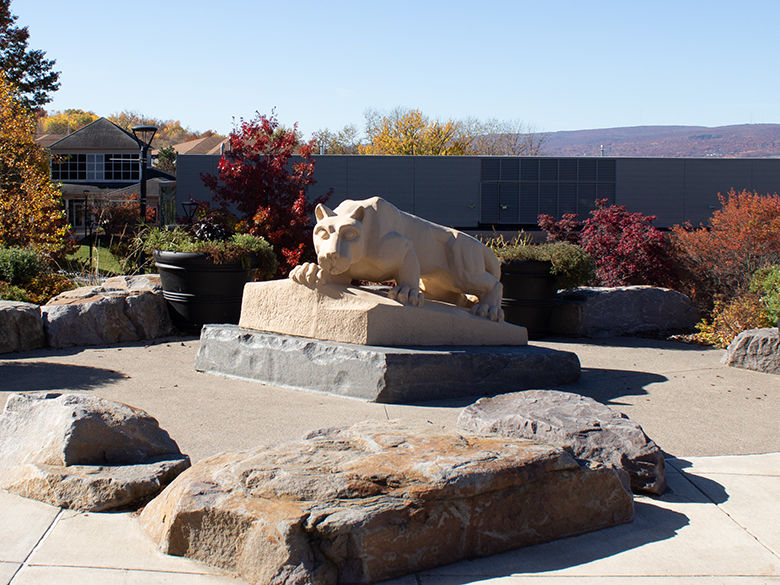 lion shrine with a scenic view overlooking the library building and the mountains in autumn