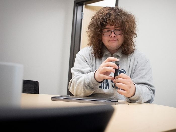 IT student worker Adam horan works on a computer keyboard