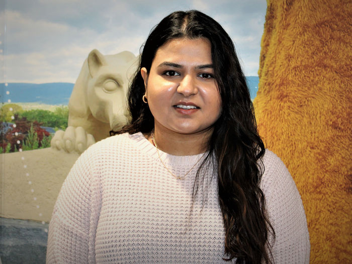 Photo of Dharti Ray in front of the Lion Shrine