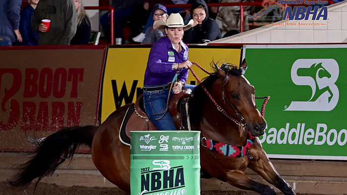 woman on horse racing around a barrel