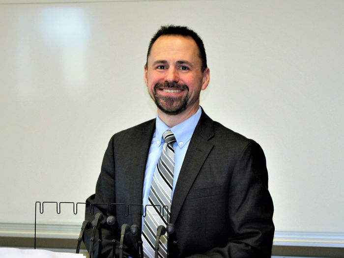 Frank Sorokach in front of whiteboard in classroom