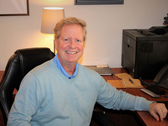 Jim Hart seated at his desk in his office