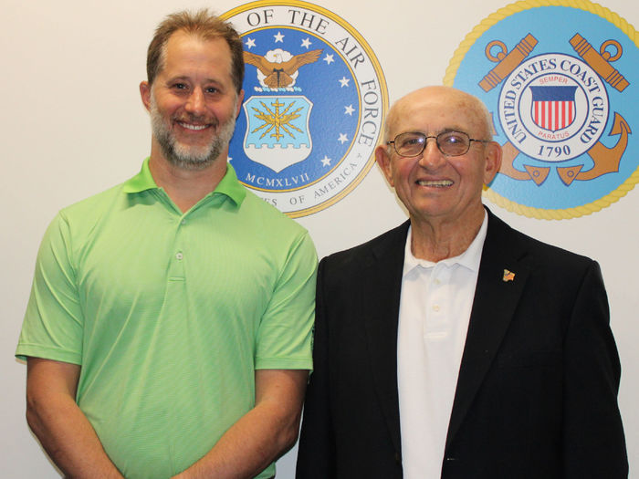 Campus alumnus EJ Long poses for a photo in the new Veterans Lounge at Penn State Scranton with retired dean of students Pat Rose