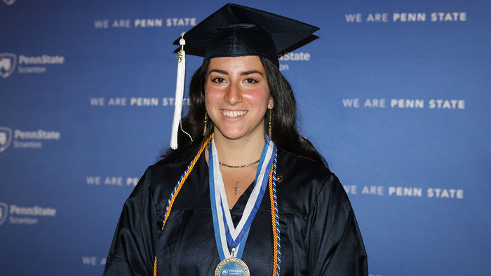 headshot of LaRosa at commencement in her cap and gown