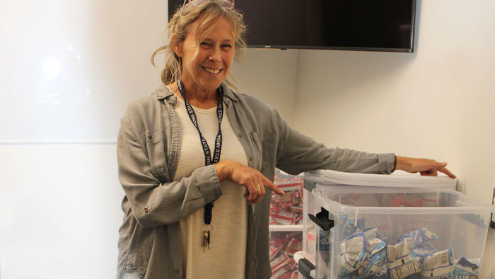 woman stocks plastic tub with snacks