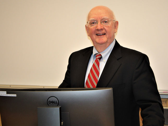 Pat Sheridan standing at Lectern in classroom