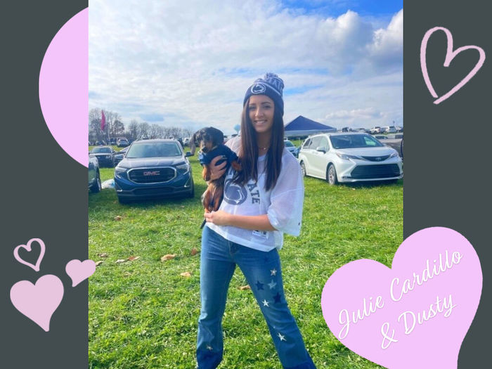 girl in penn state gear holds her mini dachshund puppy