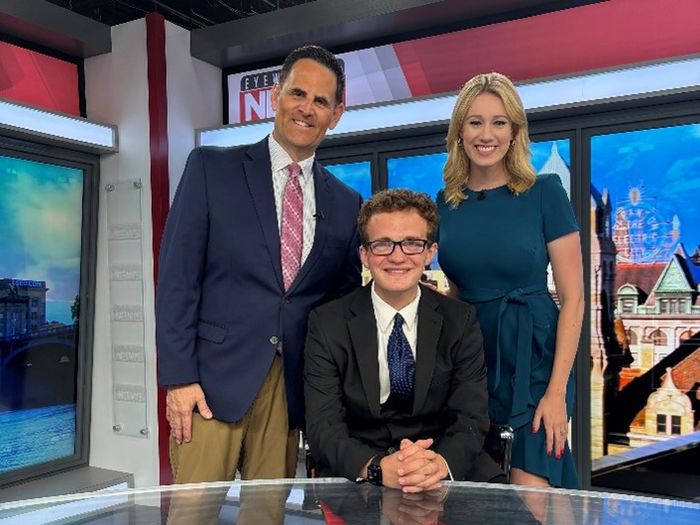 Matt Howard, center, poses on the news set with WBRE anchors Tom Williams and Kelly Byrne.