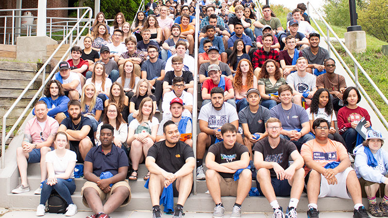 large group of students sitting on steps