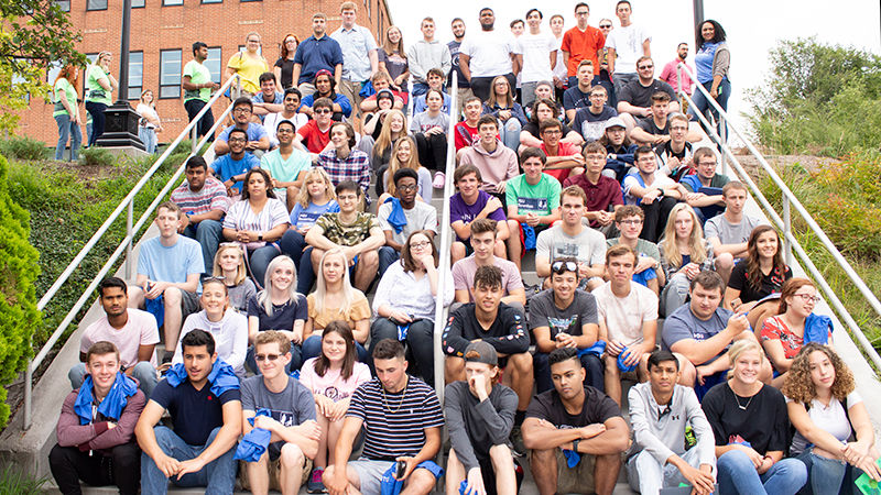 large group of students sitting on steps