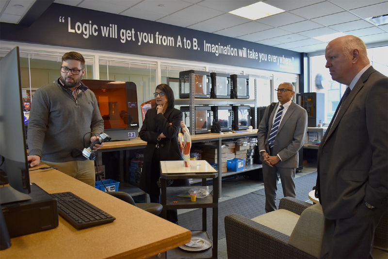 Instructor demonstrates something on computer screen for Bendapudi