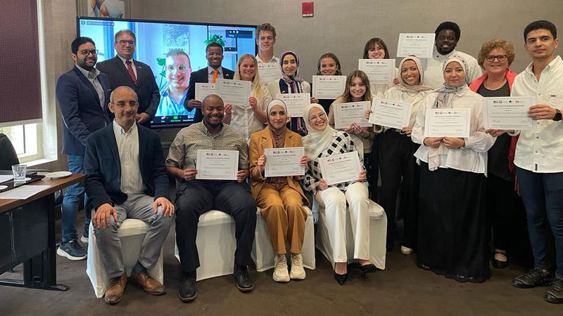 group of about 15 people holding certificates