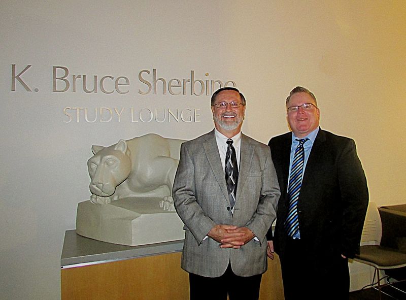 Michael True, presenter, and Career Services Coordinator Jon Tobin pose for a photo in front of nittany lion statue