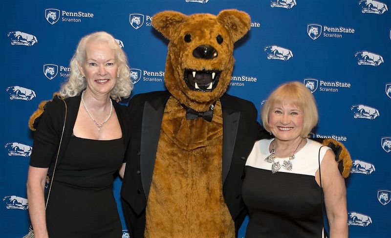 Former employees Margie and juliet pose with the Nittany Lion