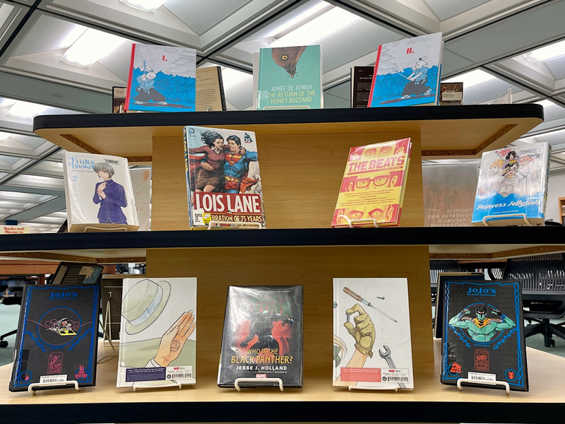 A tabletop display of various manga and graphic novels in the leisure reading section of the Penn State Scranton library