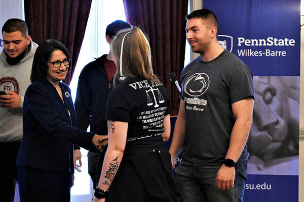 Bendapudi shakes hands with a student