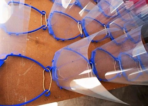 Completed face masks on a table waiting to be distributed to health care workers