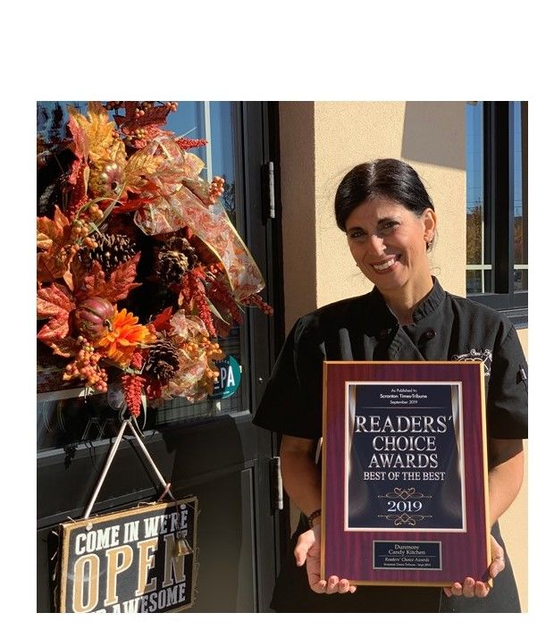 Laura Reuther holds the store's 2019 Readers' Choice Award from the Scranton Times-Tribune