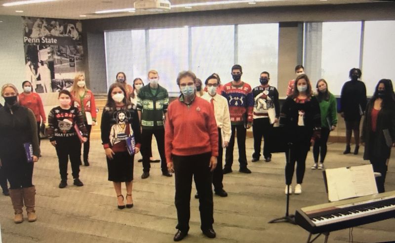 chorale members in masks practicing in the Sherbine Lounge