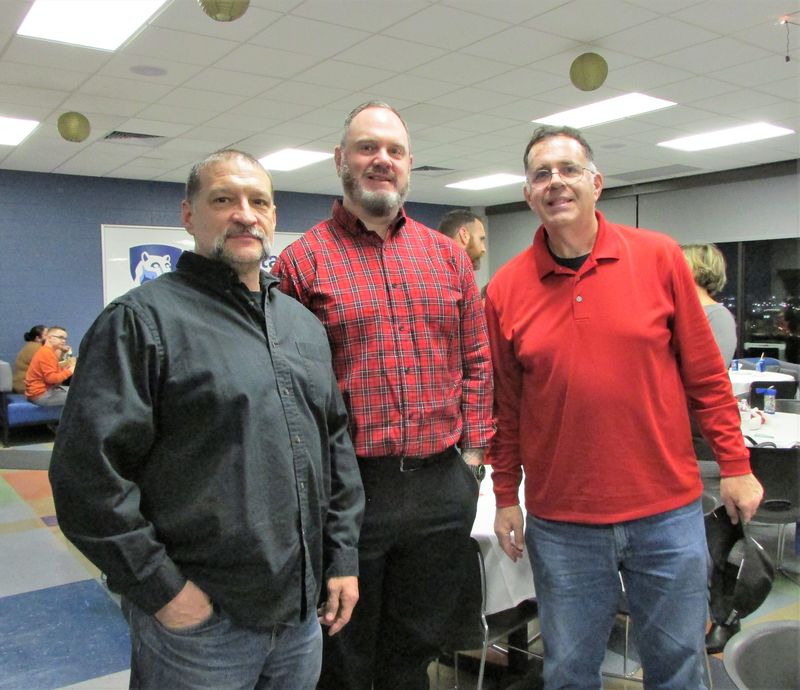 three veterans pose for a photo at the dinner