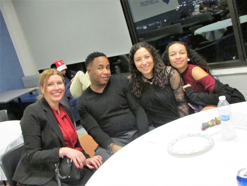 happy guests posing at table for group photo