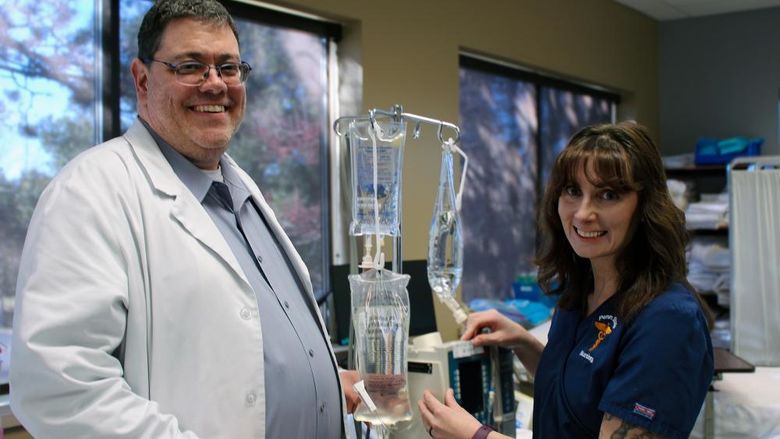 Mike Evans and Darla Lattimer pose for a photo in Penn State Scranton's nursing sim lab