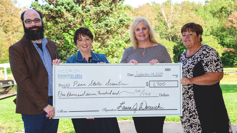 Scranton Foundation reps and Director of Development Chris Ostroski pose with grant check