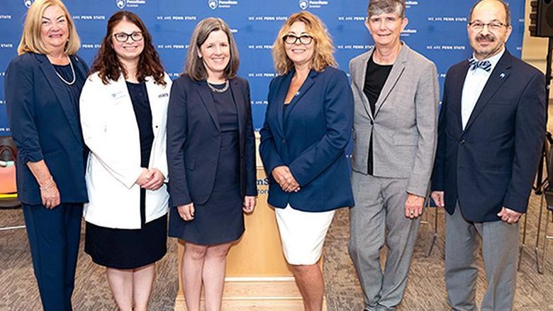 university administrators pose for a group photo prior to ribbon cutting