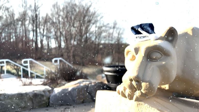 penn state scranton lion shrine statue wearing a blue penn state santa hat