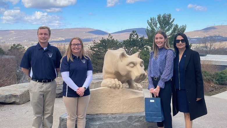 students pose with president-elect bendapudi at scranton lion shrine