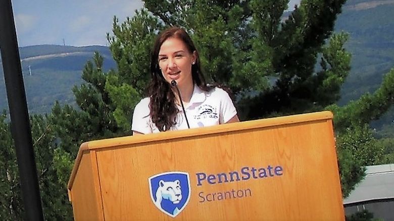 emily scarfo speaking at podium