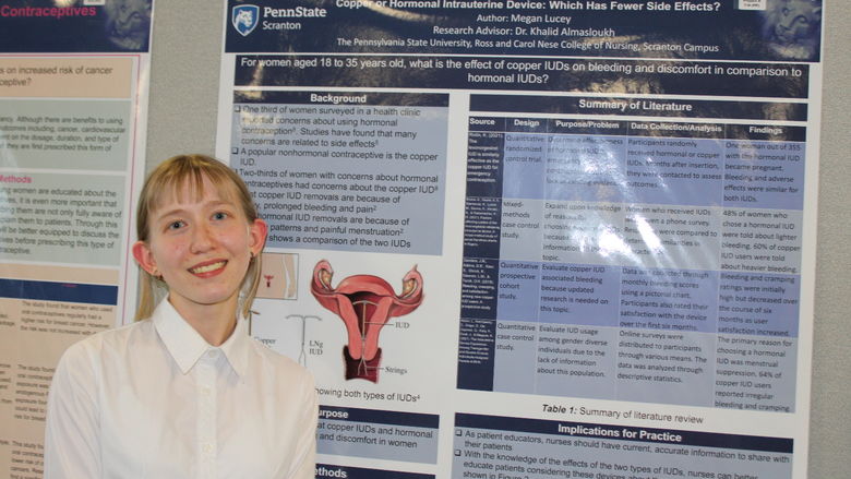 Nursing major Megan Lucey posing in front of her research poster at this year's Penn State Scranton research fair