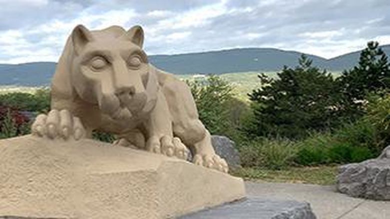 Nittany lion shrine with mountains and trees in background