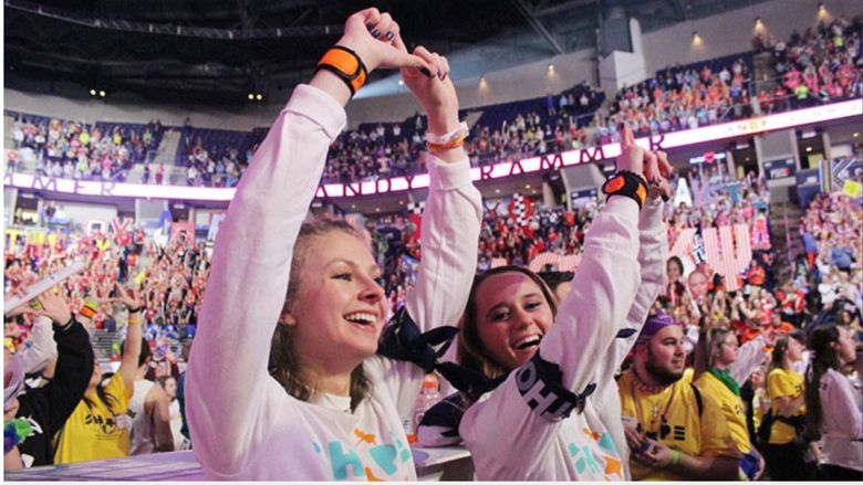 Scranton dancers Dana and Katie on the dance floor of the Bryce Jordan Center for THON, making a diamond sign with their hands.