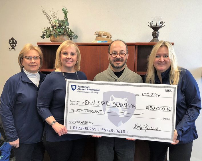 alumni officers present scholarship to chancellor