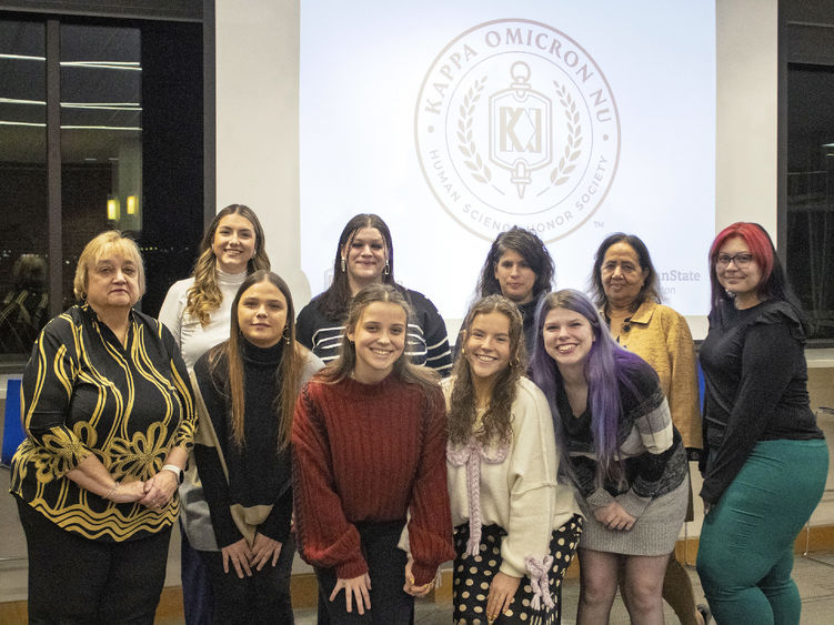 posed group of new student inductees standing with HDFS faculty