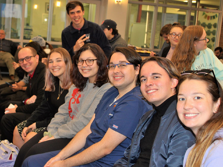 group of students seated side by side smile for the camera prior to the start of the GPA Celebration