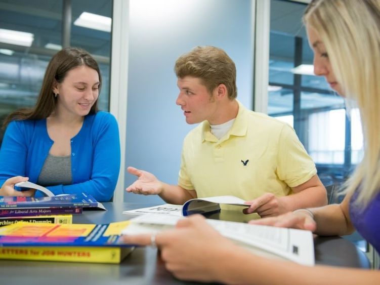 group of students studying at a table together