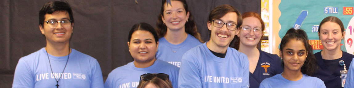 7 volunteers wearing united way day of caring tee shirts